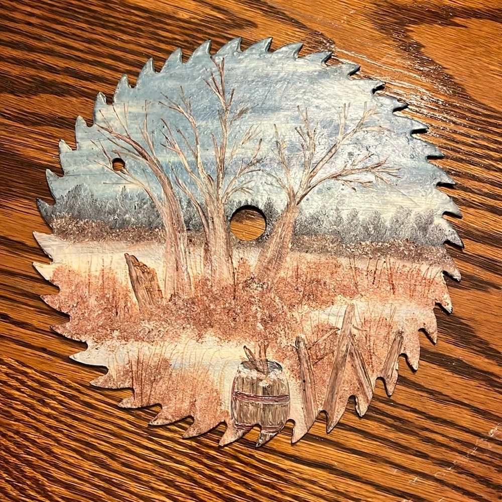 Hand painted saw blade wall decor.